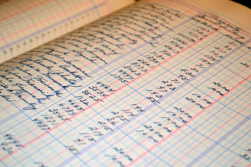 Close-up of a handwritten columnar accounting ledger representing the books of accounts Philippine small businesses must register with the BIR