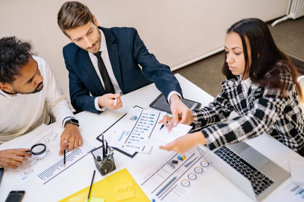 Business team reviewing payroll charts and statutory compliance documents