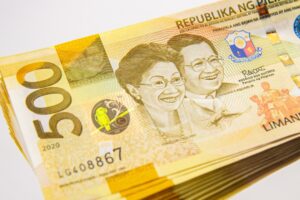 Stack of Philippine peso 500 bills representing business registration costs in PHP