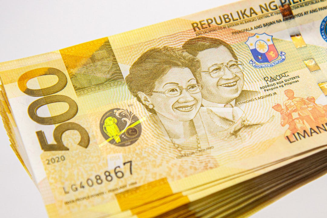 Stack of Philippine peso 500 bills representing business registration costs in PHP