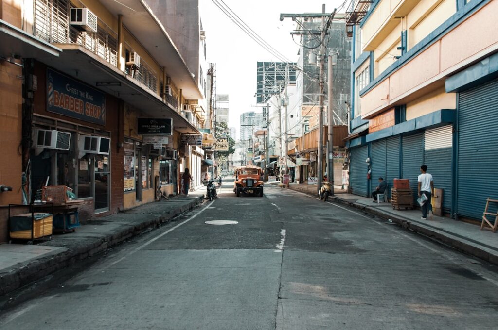 A street in Davao City Philippines with a jeepney and commercial shopfronts, representing the local SME landscape served by RDO 113A and 113B