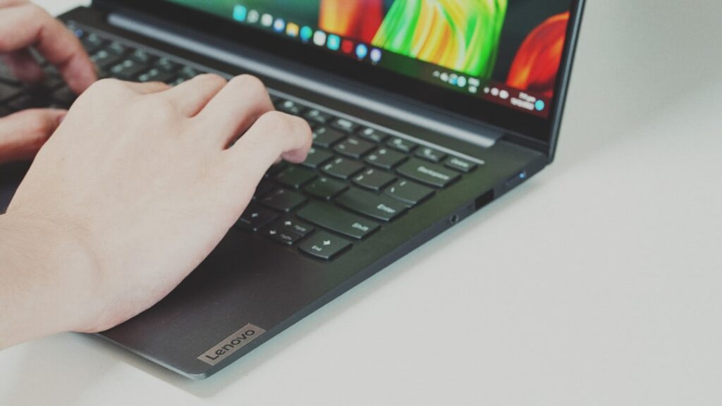 Hands typing on a laptop keyboard, illustrating the step-by-step process of filing tax returns through BIR eBIRForms